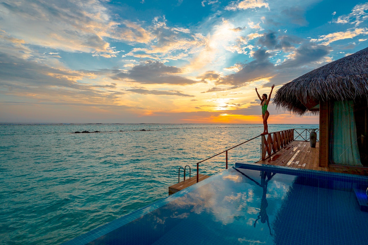 A Happy Woman and the Endless Pool with Ocean View in our Monthly Rentals on Oahu.